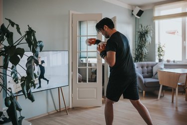 Man doing an online boxing workout in his living room