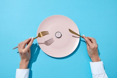 top view of a plate with a clock on it, to represent intermittent fasting